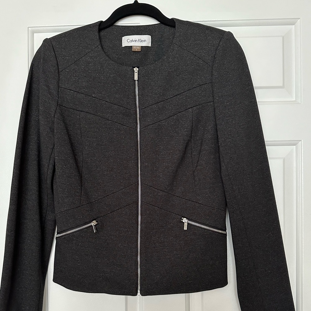 Calvin Klein lined jacket, zipper front and pockets.   Very comfortable.